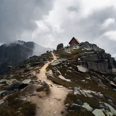 Mountain hut on rocky trail peak