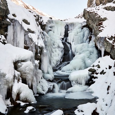 Frozen Waterfall in Snowy Mountains