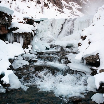 Frozen Waterfall in Snowy Mountains