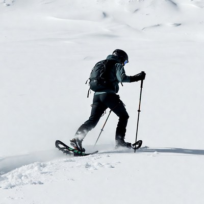 Man snowshoeing in snowy mountains