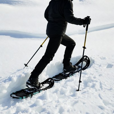 Man snowshoeing in snowy mountains