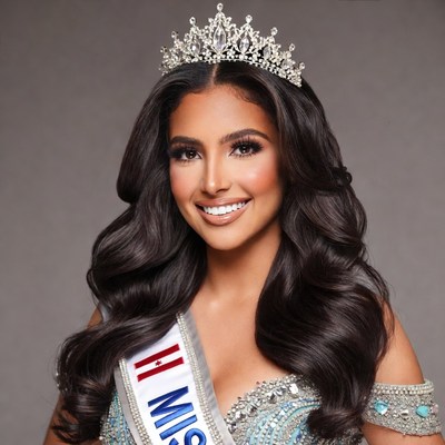 Latina woman wearing Miss sash and tiara
