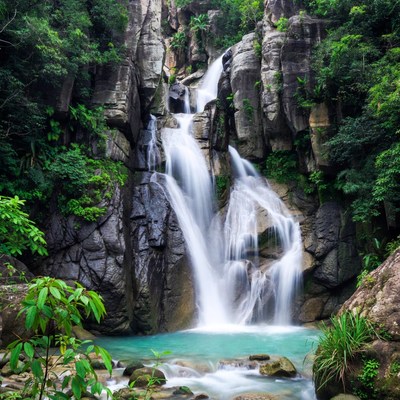 Majestic waterfall cascading into turquoise pool
