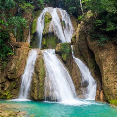 Multi-tiered waterfall in lush jungle