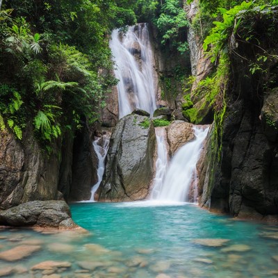 Tropical Waterfall Cascading into Turquoise Pool