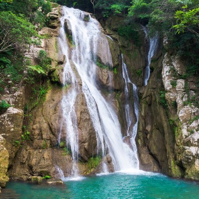 Majestic waterfall cascading into turquoise pool