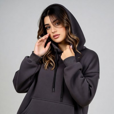 Woman in gray hoodie touching face