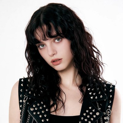 Woman in studded leather vest