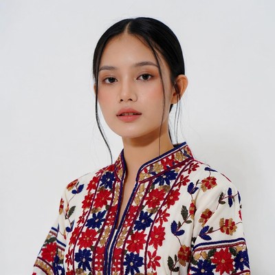 Asian woman in floral embroidered blouse