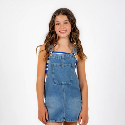 Girl smiling in blue denim overalls