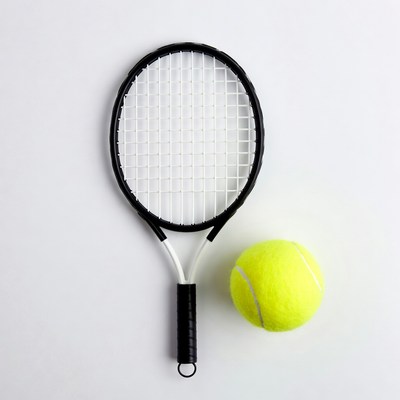 Black tennis racket and yellow ball