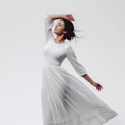 Woman dancing in white lace dress