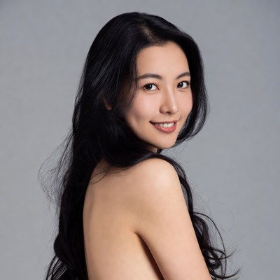 Asian woman smiling over shoulder