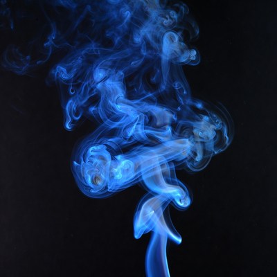 Blue smoke swirls on black background