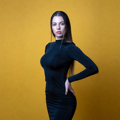 Woman in black dress on yellow background
