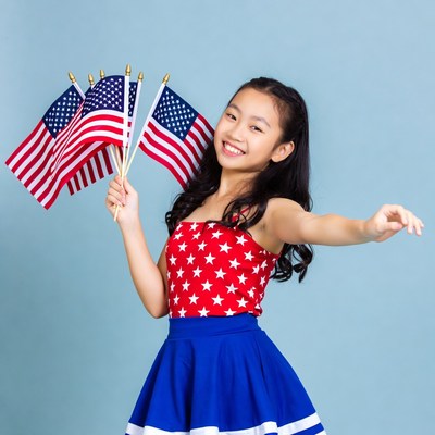 Asian girl holding American flags