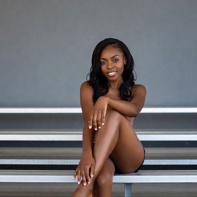 African-American woman sitting on bleachers