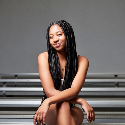 African-American woman with braids on bleachers