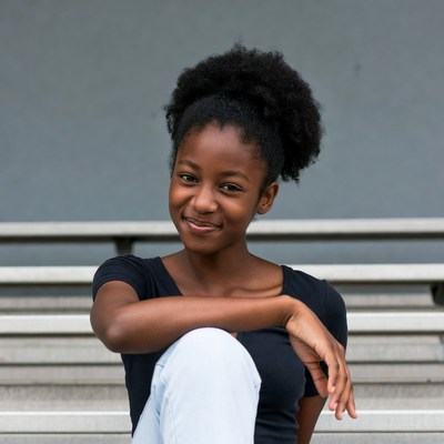Smiling African-American girl on bleachers