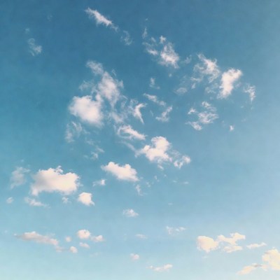 Fluffy white clouds in blue sky