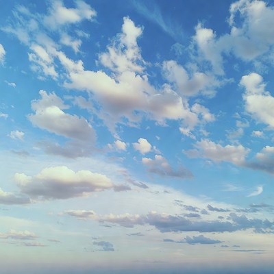 Fluffy white clouds in blue sky