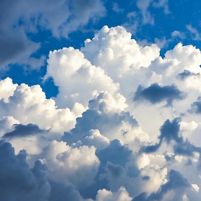 Fluffy White Clouds in Blue Sky