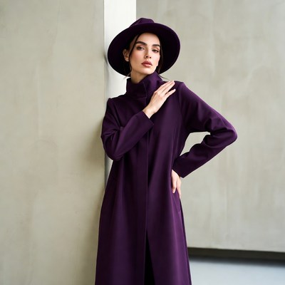 Woman in purple coat and hat