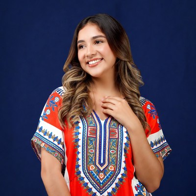 Smiling woman in orange embroidered dress