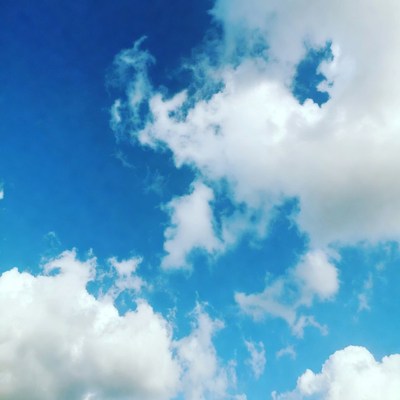 Fluffy white clouds in blue sky