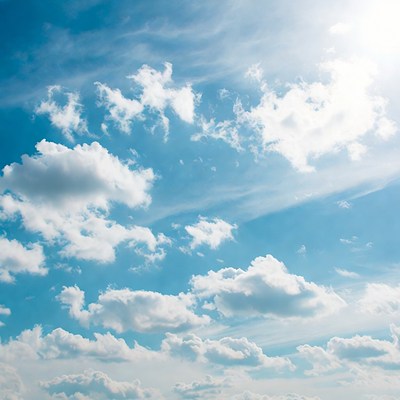 Bright blue sky with fluffy clouds