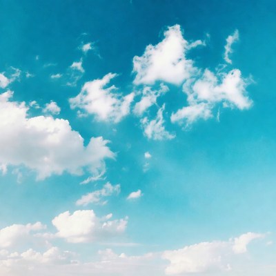 Fluffy white clouds in blue sky