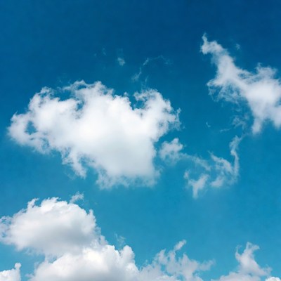 Fluffy white clouds in blue sky