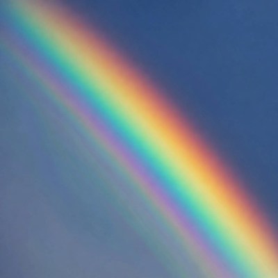 Vibrant Rainbow in Blue Sky