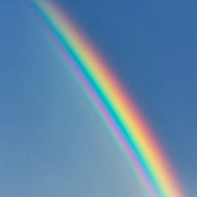 Vibrant rainbow in blue sky