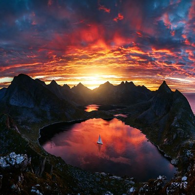 Sailboat in Mountain Lake at Sunset
