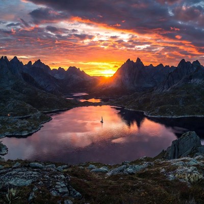 Sailboat on lake at sunset mountains