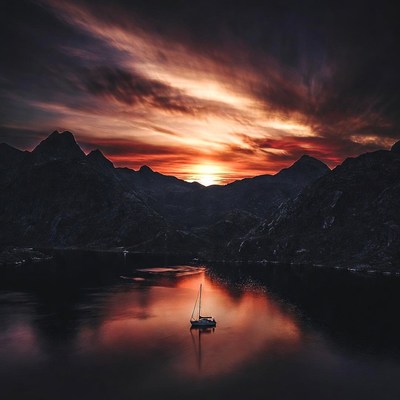 Sailboat on Lake at Sunset Mountains