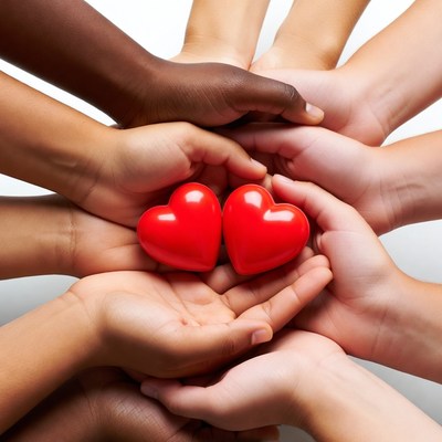 Diverse hands holding red hearts