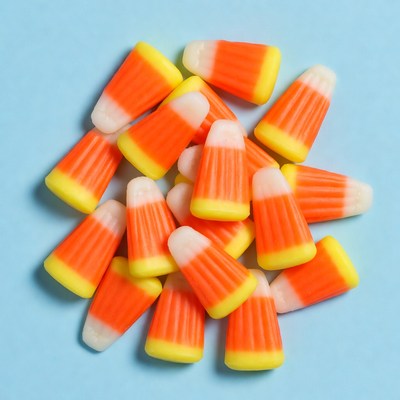 Candy corn pile on blue background