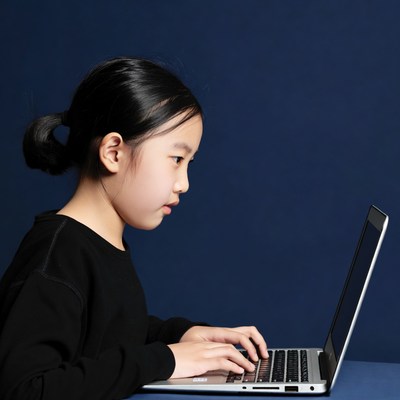 Asian girl typing on laptop
