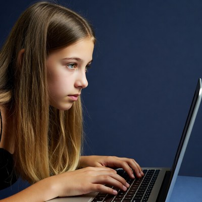 Girl typing on laptop