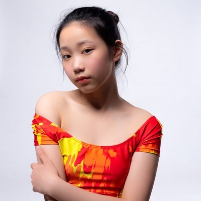 Asian girl in colorful off-shoulder top