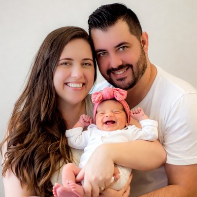 Family holding smiling newborn baby