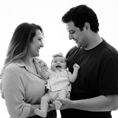 Family holding smiling baby