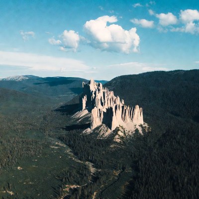 Towering Hoodoos in Forested Mountains