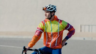 Man in colorful jacket on bicycle