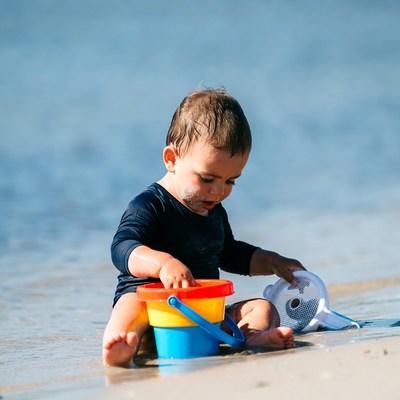 Baby playing with beach toys