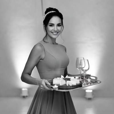 Woman serving cheese platter and wine