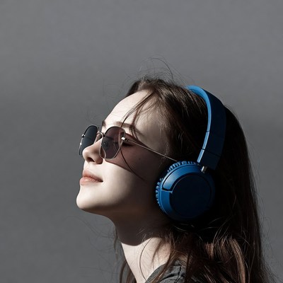 Woman wearing blue headphones sunglasses