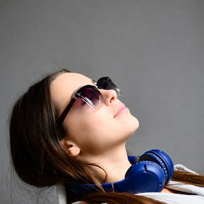 Woman with headphones looking up